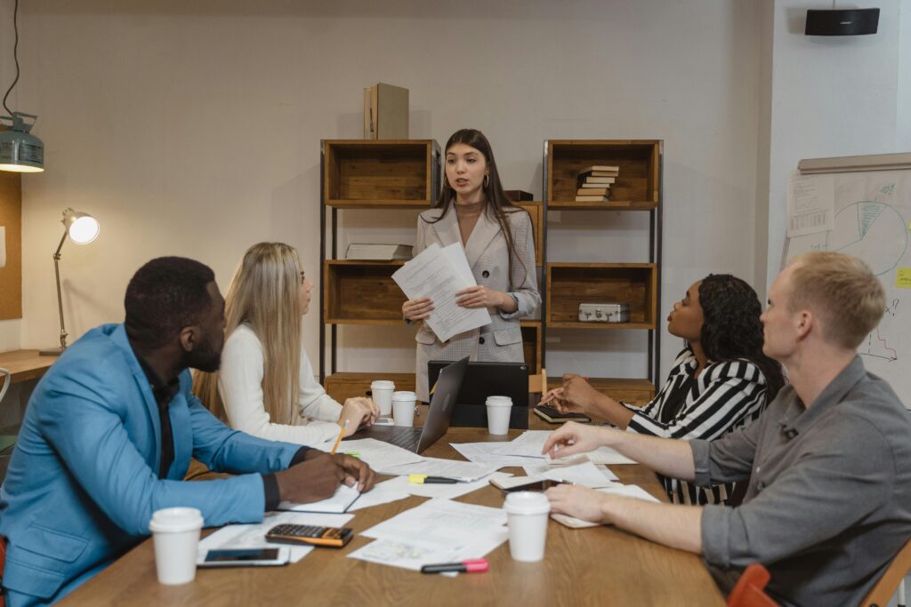 A diverse team of professionals in a creative office engaged in a collaborative business meeting.
